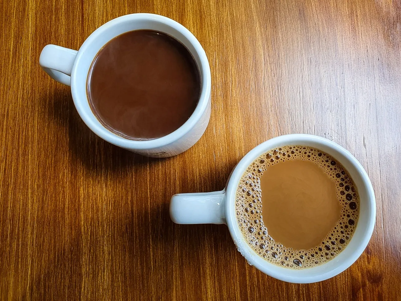 Two mugs of kopi from the Sprouts drinks stall
