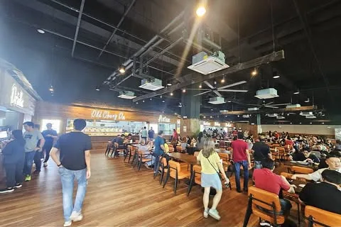 The dining hall at Sprouts Food Place Bulim Square, with the Old Chengdu stall front