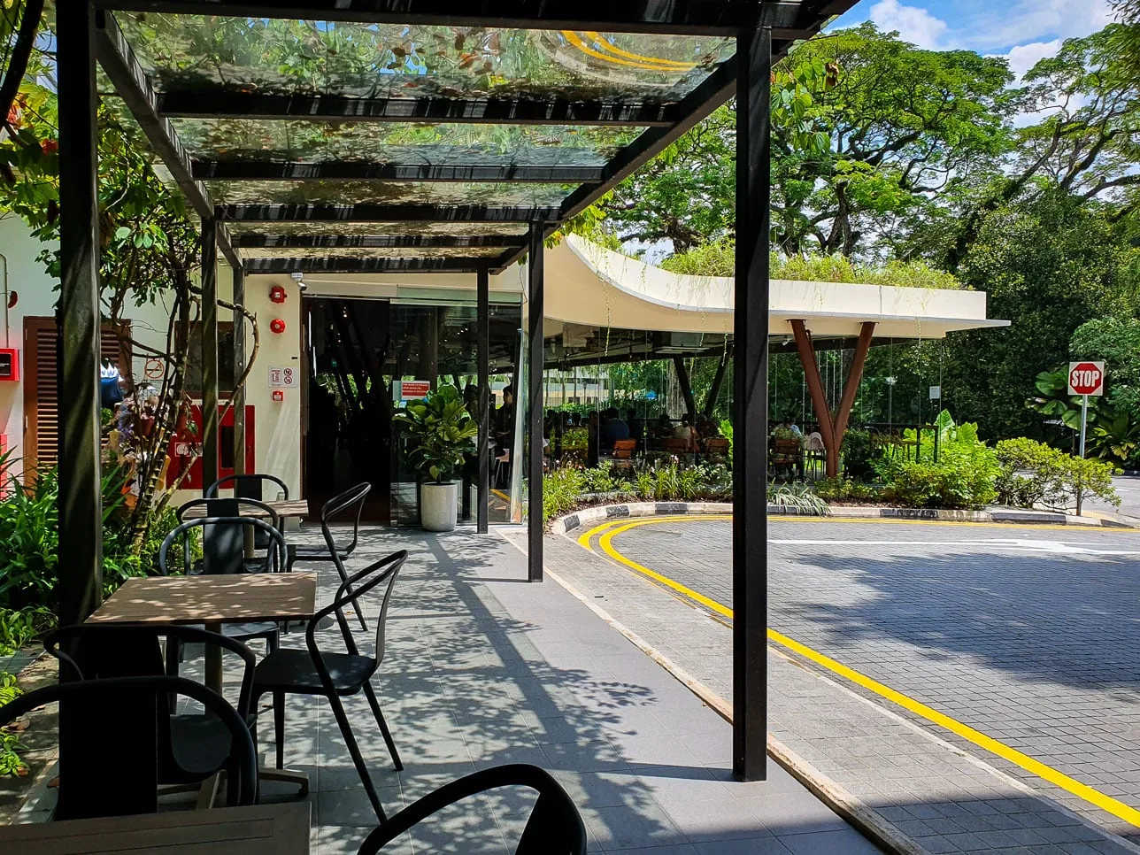 The sunlit alfresco seating under the trees at Sprouts Food Place, Cluny Road