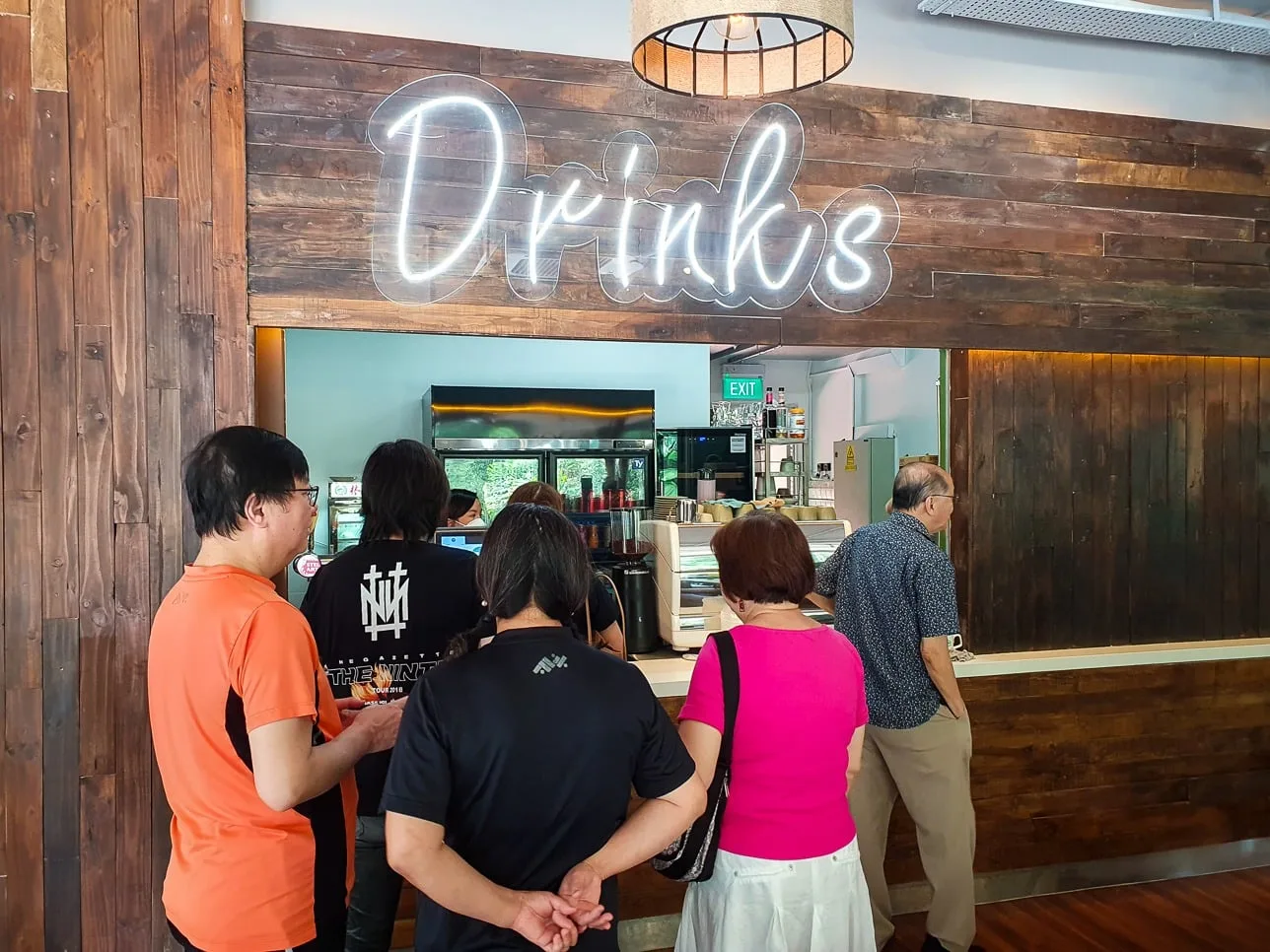 The Sprouts drinks stall counter with its neon sign